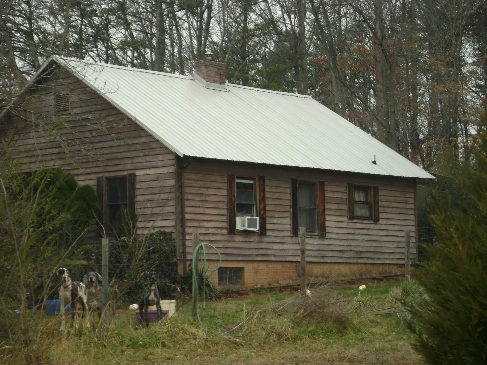 White metal roof on an old wood sided farmhouse, from a Metal Roof Installation job in Keystone